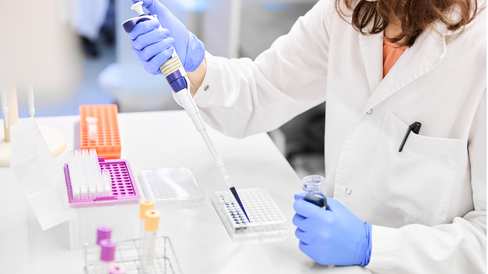 Laboratory technician pipetting liquid into a well plate in a modern research setting—illustrating Nagase’s Latex Particle technology used in precision bioassays, diagnostics, and life science applications.