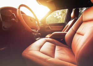 Luxury car interior with premium leather seats and steering wheel, representing Nagase Automotive Upholstery Materials for mobility, designed to enhance comfort, durability, and modern vehicle design.