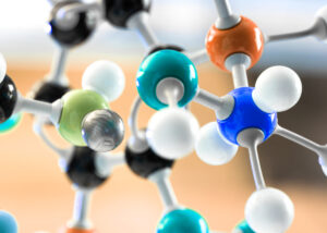Close-up of a colorful molecular structure model symbolizing Denacol Acrylate DA-141 by Nagase, a low-viscosity reactive acrylate monomer used in UV-curable resins, coatings, adhesives, and printing inks for enhanced adhesion and flexibility.