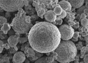 High-resolution SEM image of spherical cathode material particles by Nagase Mobility, showcasing uniform granular structure ideal for automotive battery technology, enhancing energy density and stability in electric vehicle applications.
