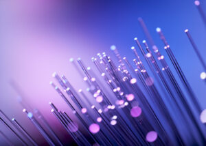 Close-up of illuminated fibers symbolizing flat chopped glass fibers from Nagase, providing reinforcement, durability, and performance enhancement in advanced plastics and compound applications.