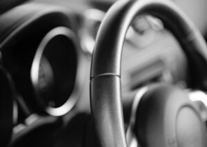 Close-up of a car steering wheel surface coated with oxazoline functional polymers, enhancing durability, adhesion, and performance in automotive paint and coating solutions from Nagase.
