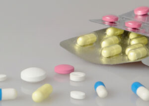 Assorted pharmaceutical tablets and capsules on a clean surface, representing Pullulan for pharmaceuticals by Nagase, a versatile excipient that enhances stability, safety, and performance in drug formulations.