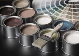 Colorful paint cans with brush, showcasing coatings enhanced by Nagase aluminum paste for improved brilliance, durability, and performance in advanced paint and coating applications.
