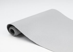 Light gray silicone-glass fabric roll used as thermal barrier material for electric vehicle battery packs, providing heat and impact resistance.