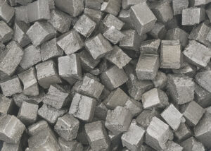 High-purity Terbium metal cubes with metallic luster, used in advanced alloys, phosphors, and clean energy applications supplied by NAGASE.
